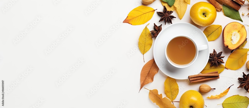 Poster Autumn-themed flat lay with tea, lemon, honey, apples, and leaves on a white backdrop with copy space image. Ideal for conveying a cozy fall atmosphere.