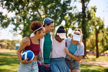 Fototapeta premium Young happy friends having fun playing volleyball in nature.