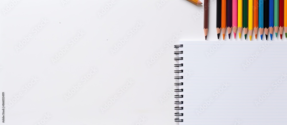 Aufkleber Notebook and basic pencils displayed on a white backdrop with copy space image.