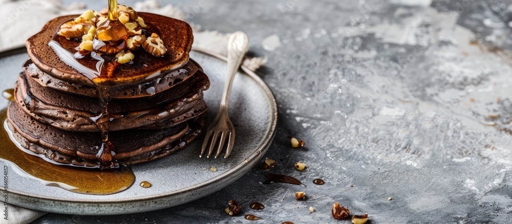 Poster delicious healthy breakfast snack featuring chocolate pancakes topped with honey and nuts on a plate