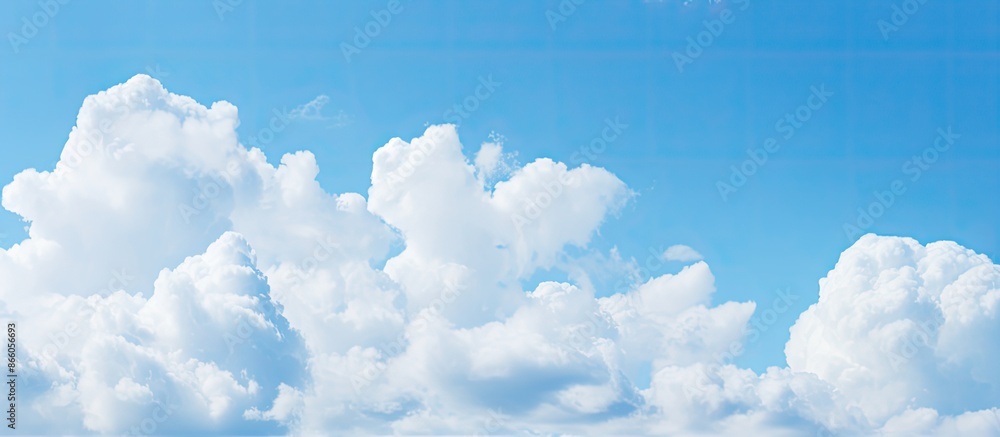 Poster Soft focus on white clouds against a blue sky background with a horizontal shape ideal for copy space image.