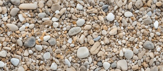 Close-up shot of beach sand with stones, perfect for background or texture, with copy space image.