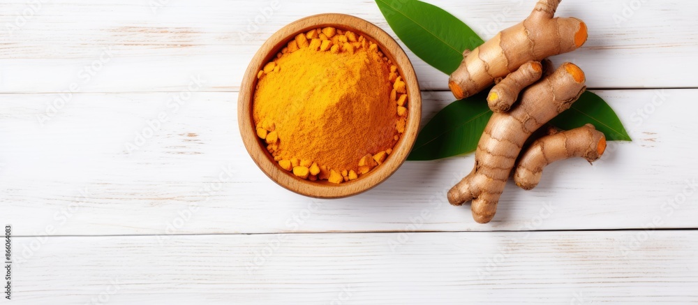 Poster top view of turmeric powder in a wooden bowl and turmeric root isolated on a white background with c