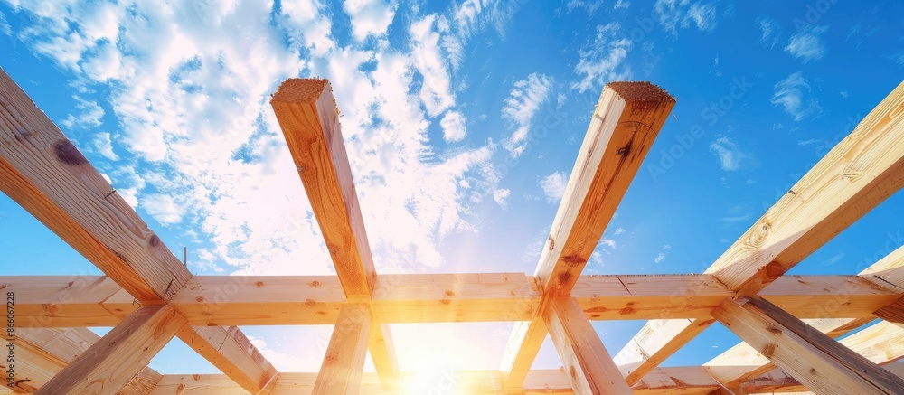Poster Looking up at new construction beams under a clear blue sky with sunlight. with copy space image. Place for adding text or design
