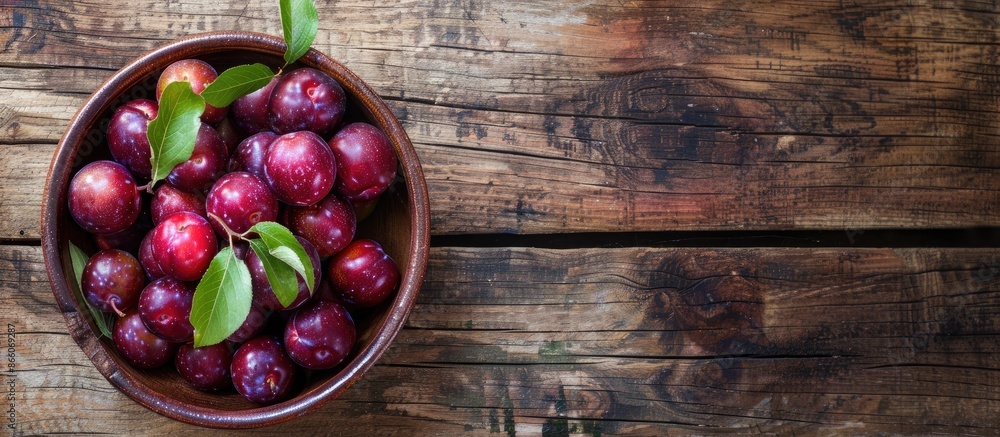 Aufkleber juicy organic plums in a rustic ceramic bowl on a wooden background, creating a charming copy space 