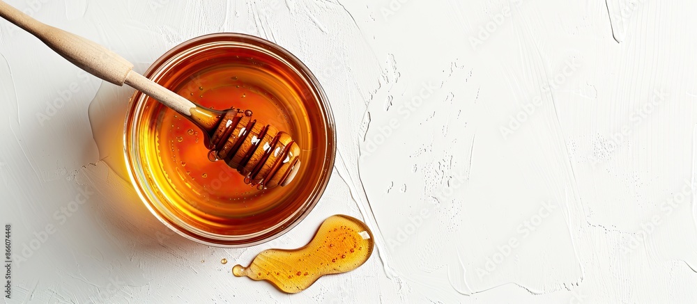 Poster delicious honey jar with a wooden honey dipper arranged on a white background providing a top view w