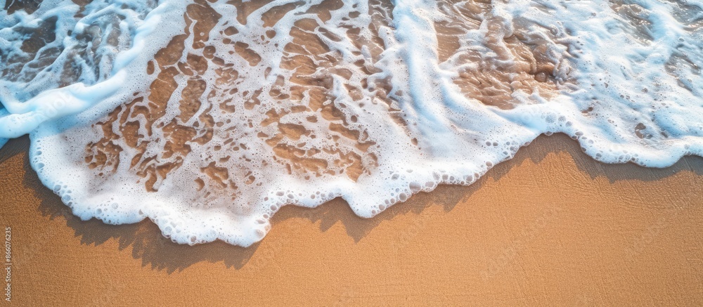 Aufkleber a gentle wave gently rolls onto the sandy beach in the summertime, providing a serene backdrop for s