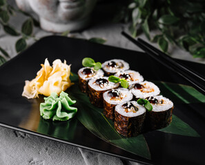 Gourmet sushi platter on elegant black plate