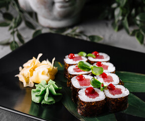 Gourmet tuna sushi rolls on elegant black plate