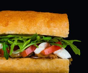 Fresh italian sub sandwich on black background