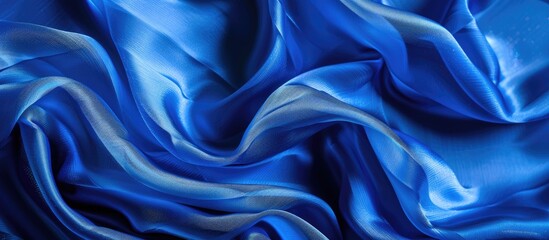 Fototapeta premium Embrace this vivid Electric Blue silk fabric as your ultimate accessory, with its enchanting elasticity and flawless appeal, perfect for a copy space image.