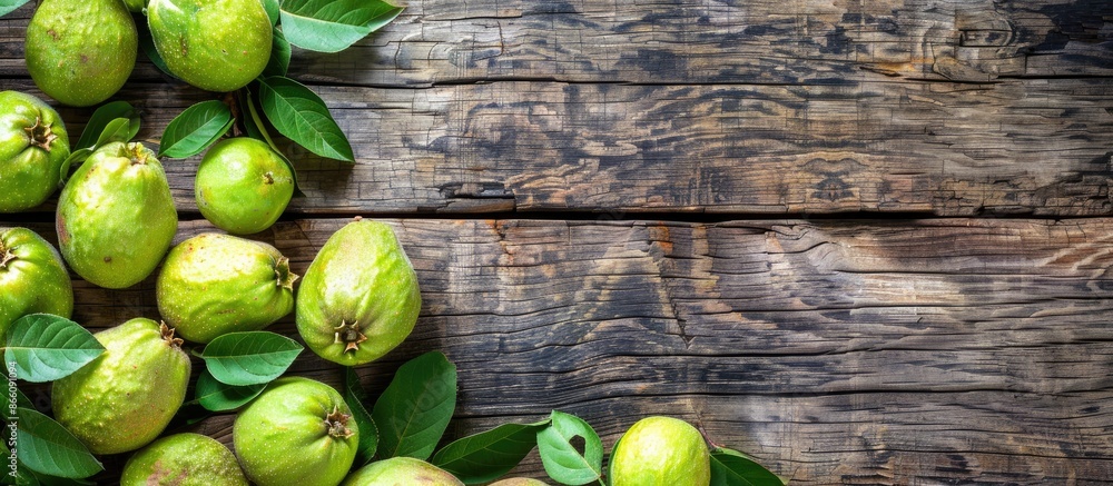 Poster Top view of ripe green guavas displayed on a rustic wooden surface with copy space image.