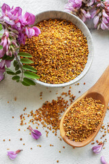 Healthy bee pollen grains.  Bee pollen on a bowl and acacia flowers.