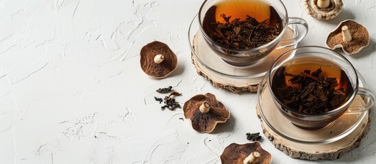 Chaga tea served in clear bowls on a white backdrop with birch mushroom infusion, providing ample copy space image.