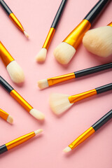 Brush set for make-up on pink background. Vertical photo