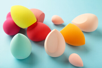 Beauty blender on blue background. Makeup products. Beauty concept.