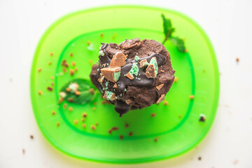 Homemade delicious double chocolate chip mint iced cookies, freshly baked at home with Mum and Daughter.  Stacked on a bight green plate looking super fresh!