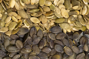 Different types of peeled pumpkin seeds, top view
