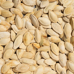 Close-up of unpeeled pumpkin seeds from above.