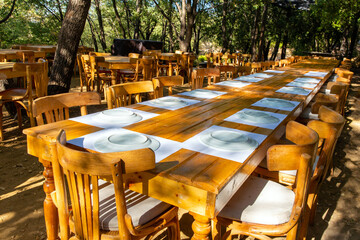 Long wooden table for group of guests in a rustic restaurant