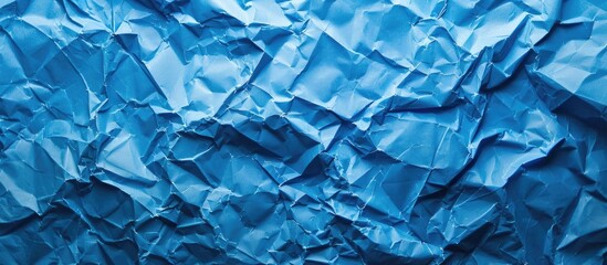 Obraz premium Blue crumpled paper with copy space image.