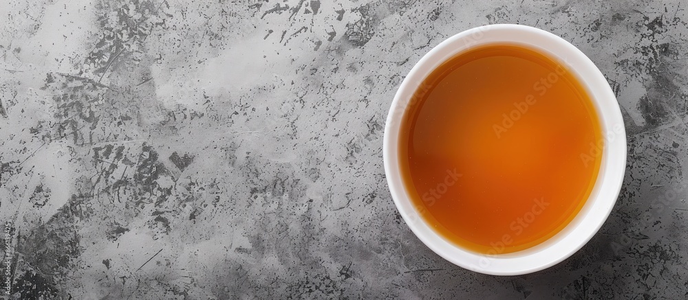 Poster top view of a bowl of broth on a gray background, perfect for a copy space image with a panoramic ba