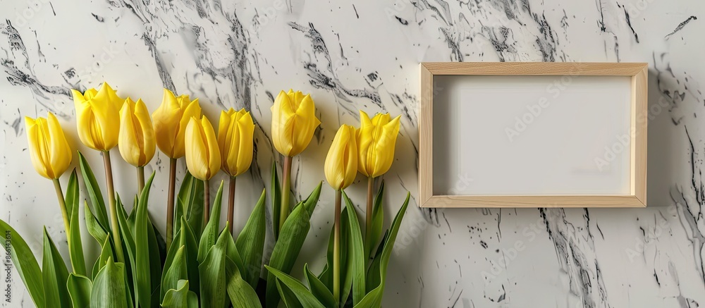 Aufkleber copy space image featuring yellow tulips displayed with a white marble background and a blank pictur