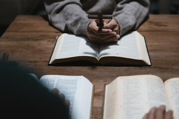 Asian men and women hands praying to god with the bible. Pray for god blessing. Religious beliefs Christian life crisis prayer to god.