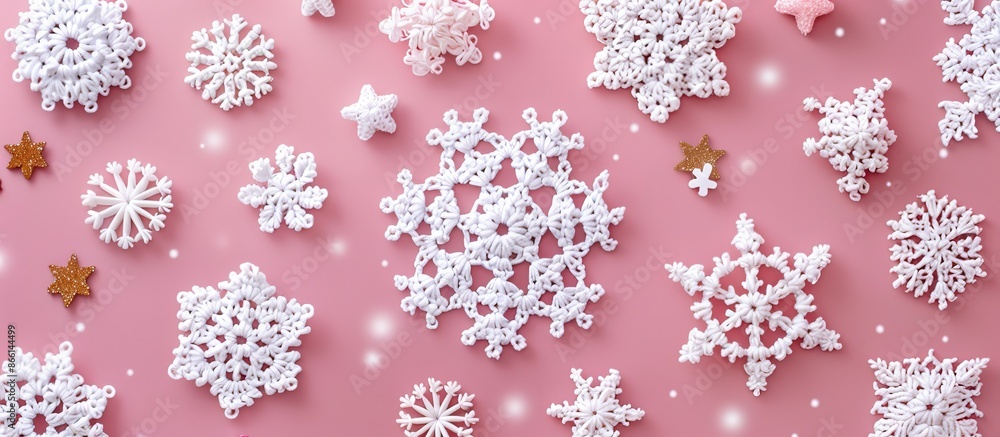 Aufkleber Crocheted white snowflakes and stars arranged on a pink background in a Christmas-themed composition with a top-down view, flat lay presentation, and space for inserting images