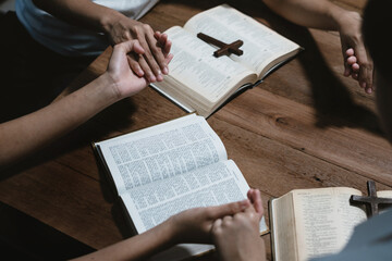 Asian men and women hands praying to god with the bible. Pray for god blessing. Religious beliefs Christian life crisis prayer to god.