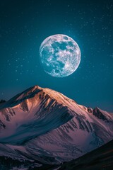 The moon rising over a mountain range, with a softly blurred background of a twilight sky and stars. 