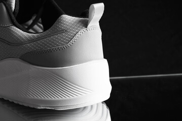 Close-up of the back of a summer sports sneaker with a breathable surface and an air sole. Sports...