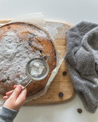 Home baking with young child, making super yum chocolate chip vanilla cake with confectioners sugar...