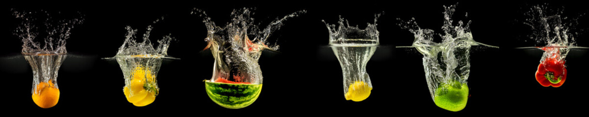 Group of falling fruits and vegetables in water with splash on black background