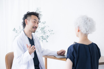 Doctor examining an elderly patient Image of interview, consultation, and counseling in internal...