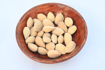 Almond with shell. It's other name Prunus amygdalus and Prunus dulcis. The almond is also the name of the edible and widely cultivated seed of this tree. indian almond.