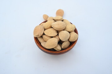 Almond with shell. It's other name Prunus amygdalus and Prunus dulcis. The almond is also the name of the edible and widely cultivated seed of this tree. indian almond.