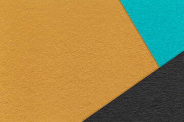 Texture of craft dark yellow color paper background with blue and black border. Vintage abstract ocher cardboard.