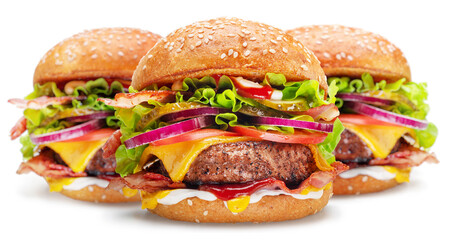 Beef patty burgers with vegetables and lettuce on white background.