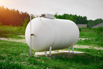 Rural home with large white propane gas tank
