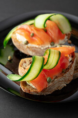 Sandwiches with smoked trout, cream cheese, fresh cucumber, and capers.