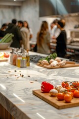 An elegant, marble kitchen island in the foreground with a blurred background of a high-end cooking class. The background features participants learning from a celebrity chef