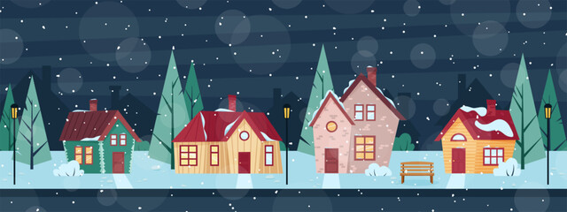 A snow-covered street with cozy houses. Winter evening in the village.