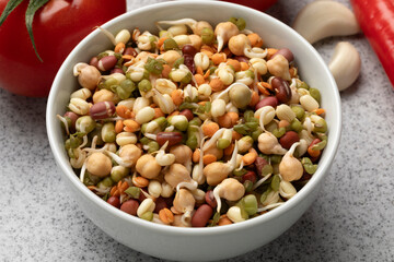 Bowl with a mixture of fresh colorful sprouts close up