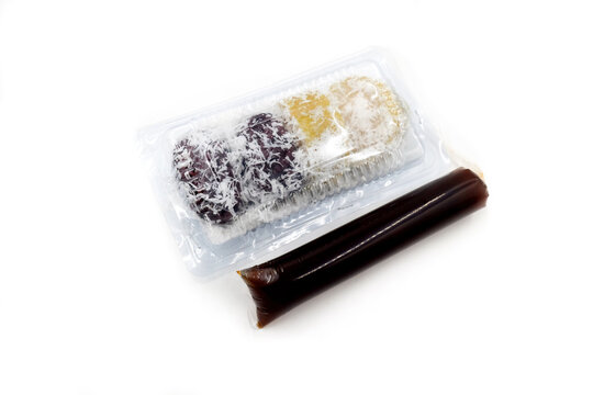 white sticky rice doused with red palm sugar sauce, or what is also known as kue lopis or lupis