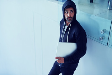Stealing, laptop and man in hoodie for crime, theft or taking digital information from office...