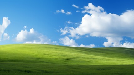 Fototapeta premium Idyllic green hill under a blue sky with fluffy white clouds. Concept of nature, peace, serenity, and tranquility.
