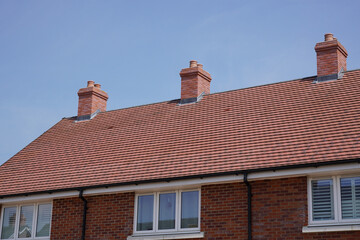Obraz premium property rooftops of new build houses. Housing development in the UK 