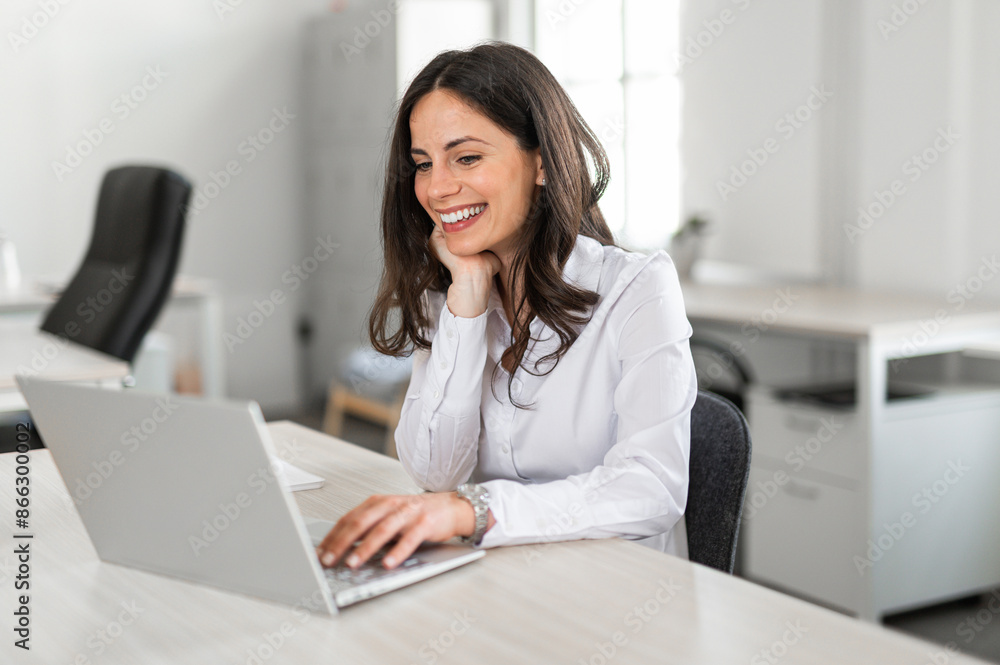 Wall mural Young female entrepreneur happily working in her office