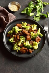 Beef with broccoli in asian style on dark background